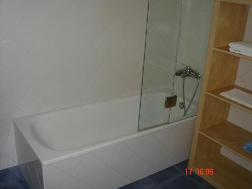 リスボンにあるInglesinhos Loftのバスルーム(シャワー、白いバスタブ付)