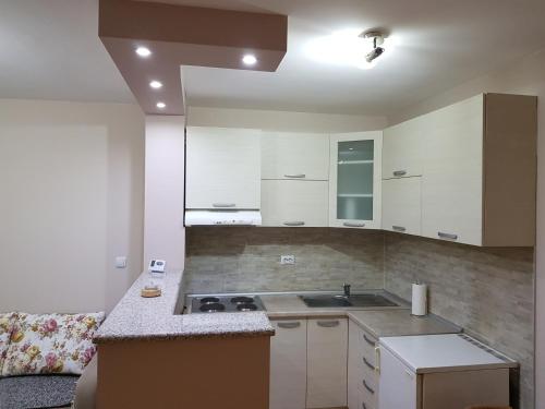 a kitchen with a sink and a stove in it at Sunce in Šabac