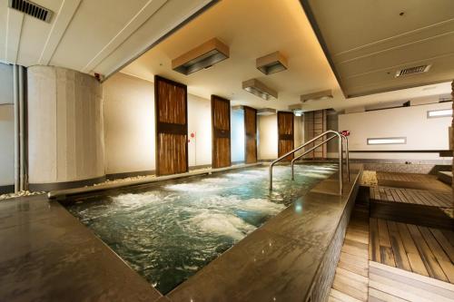 a large room with a large window and a large pool of water at Beitou Hot Spring Resort in Taipei
