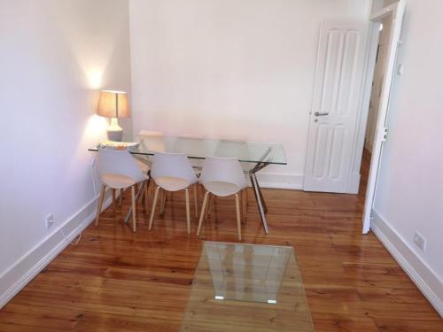 a dining room with a glass table and chairs at Monte Agudo Angola 45 in Lisbon