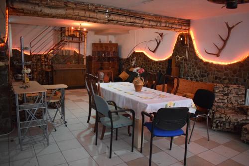 a dining room with a table and chairs at Casa Parvu in Lunca Mare