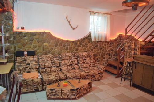 a living room with a couch and a table at Casa Parvu in Lunca Mare