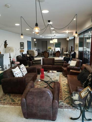 a living room with leather couches and a living room with at Quinta do Mosteiro in Felgueiras