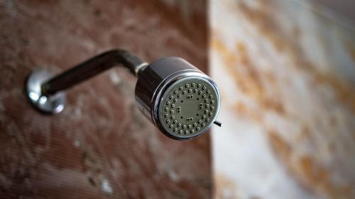 a flashlight hanging on a brick wall at Pooja Villa Suites-Rooms and Pool, Igatpuri in Igatpuri