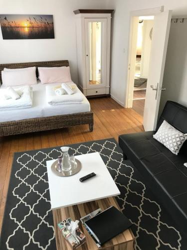 a living room with a bed and a couch at Fachwerkhaus in der Altstadt in Lüneburg