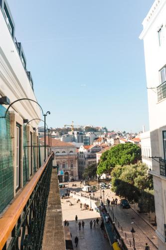 a view of a city from the balcony of a building at Rossio Boutique Hotel in Lisbon