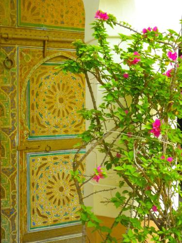 a wooden door with pink flowers in front of it at Riad Laila in Marrakech