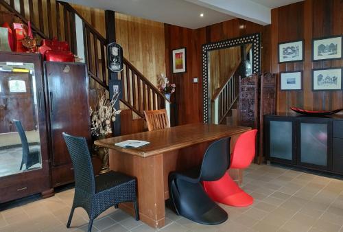 a dining room with a wooden table and chairs at Kairos Villa in Seremban