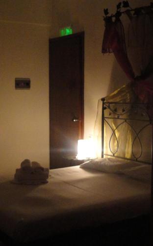 a room with a bed and a light in the dark at Kastalia in Ammouliani