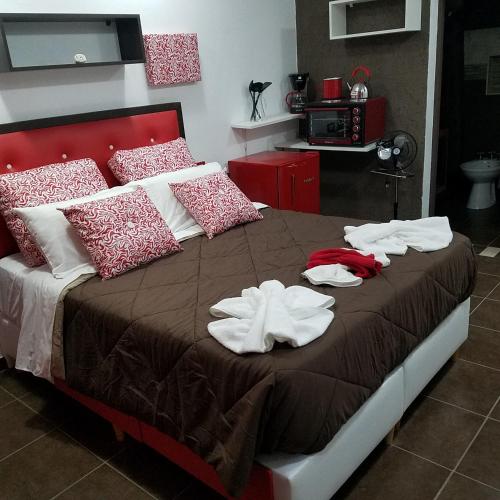 a bedroom with a bed with towels on it at Complejo Los Cipreses in Villa Carlos Paz