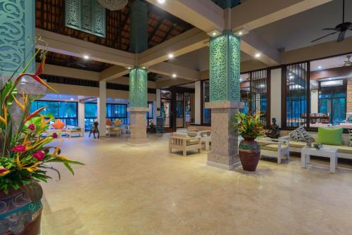 a lobby of a resort with tables and chairs at The Briza Beach Resort, Khao Lak SHA Extra Plus in Khao Lak