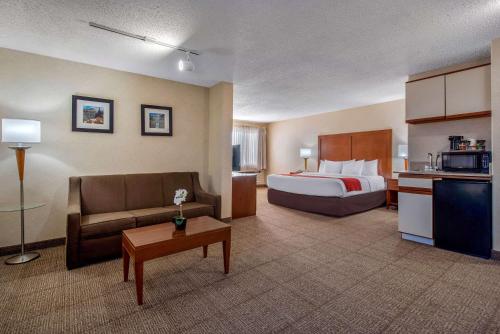 a hotel room with a bed and a couch at Comfort Inn Denver Southeast Area in Aurora