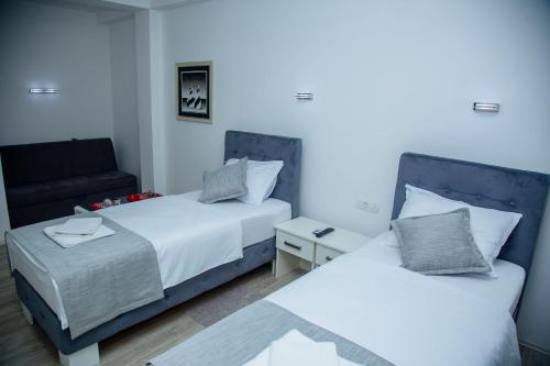 a bedroom with two beds and a couch at Mark's Palace in Nikšić