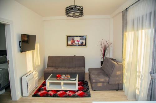 a living room with a couch and a table at Mark's Palace in Nikšić