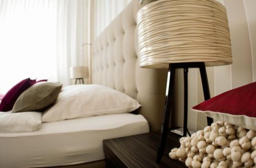 a bedroom with a bed and a lamp on a table at City Hotel Bosse in Bad Oeynhausen