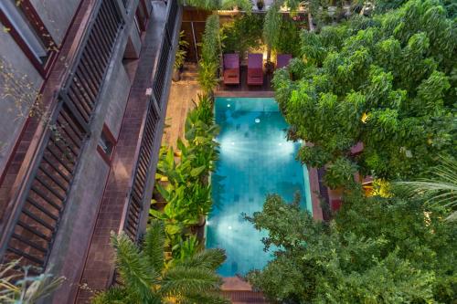 an overhead view of a swimming pool in a building with trees at Won Residence & Spa in Siem Reap