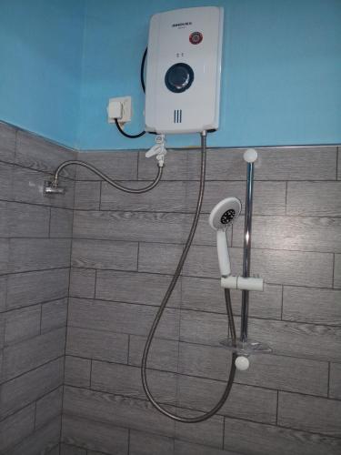 a shower in a bathroom with a camera on the wall at Sigiri Leisure Holiday Home in Sigiriya