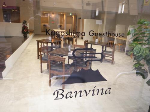 a restaurant with a table and chairs in a room at Guesthouse Banvina in Kagoshima