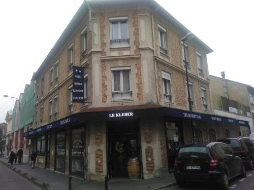 a building with a sign on the side of it at Le Kleber in Montreuil