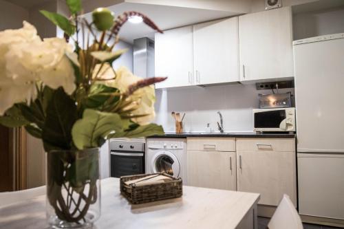a kitchen with a vase of flowers on a counter at Tudela balcón de Bardenas in Tudela