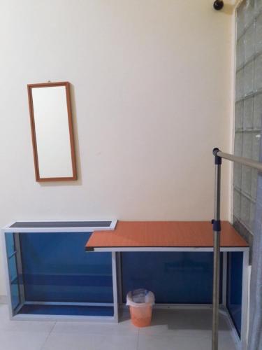 a table in a room with a mirror on the wall at Jakson Homestay in Batam Center