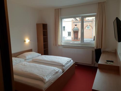Posteľ alebo postele v izbe v ubytovaní FairSleep Motel Hainburg