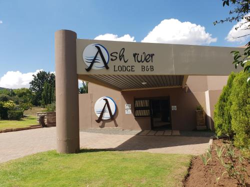 a building with a sign for a la tler lodge box at Ash River Lodge in Clarens