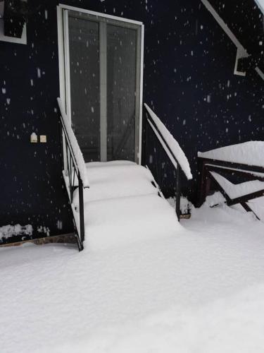 a bed covered in snow in a room at Apartman Vrdničak in Vrdnik