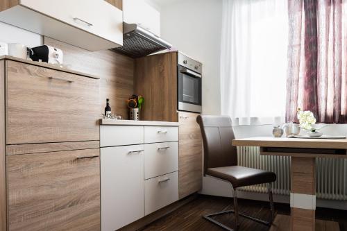 a small kitchen with a desk and a table at Appartements-Dalila in Sankt Michael im Lungau