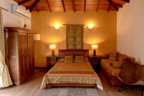 a bedroom with a bed and a couch at Villa 49 in Kandy