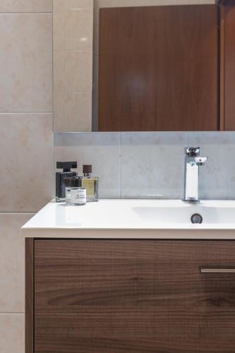 a bathroom with a sink and a mirror at Residenze Su Planu in Cagliari