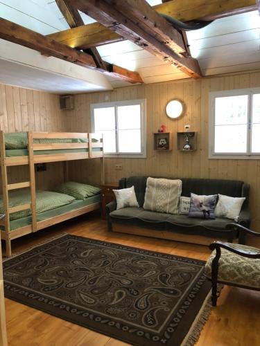 a living room with bunk beds and a couch at Chalet anno 1794 in Rettenegg