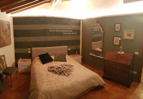 a bedroom with a large bed and a mirror at La Suite dei Ricordi in Impruneta