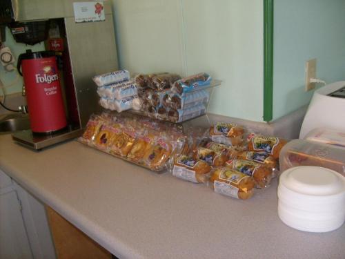 a counter with a bunch of bags of donuts at Express Inn Thomson in Thomson