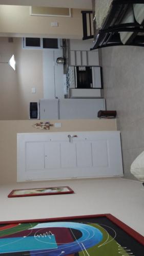 a kitchen with white cabinets and a counter top at Edificio Rivera Este in Colón