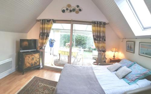 a bedroom with a bed and a large window at la frégate blanche in Concarneau