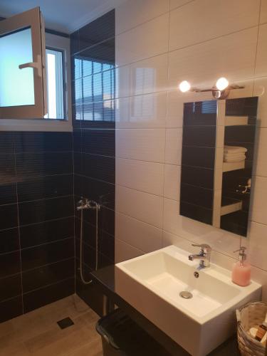 a bathroom with a sink and a shower at Hestia in Kos