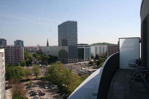 a view of a city from the balcony of a building at Holiday at Alexanderplatz Apartments in Berlin