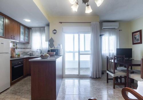 a kitchen with a table and a kitchen with a dining room at Apartamento frente al mar - 500 Mbps in Puerto de Sagunto