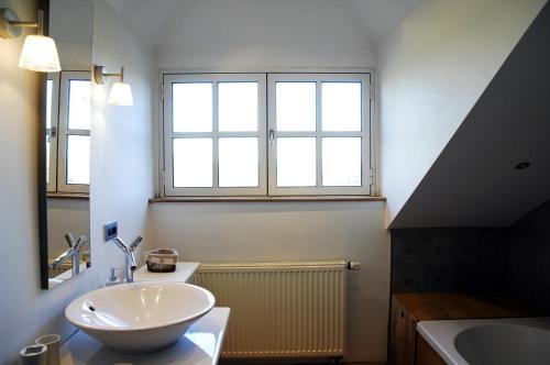 a bathroom with a sink and a large window at B&B La Buissonniere in Xhoris