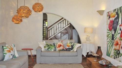 a living room with a couch and a table at Fantastic spacious beachfront VILLAVACANCES in Grand Baie