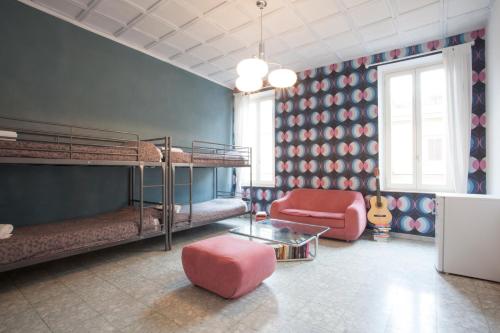 ローマにあるサラズ B＆Bの二段ベッド2台と椅子が備わる客室です。