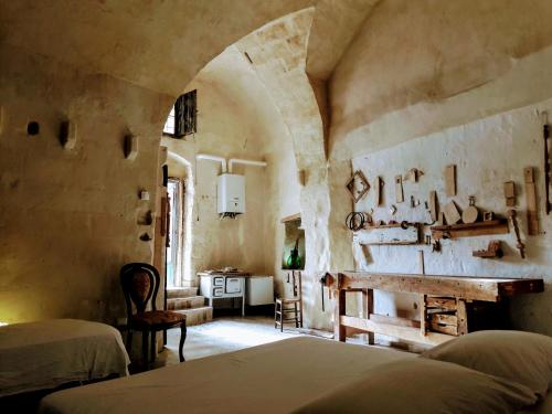 1 dormitorio con 1 cama y chimenea en una habitación en Cave Rooms Sassi, en Matera