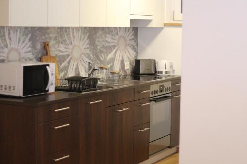 a kitchen with a microwave and a stove top oven at Haus Siegfried in Churwalden