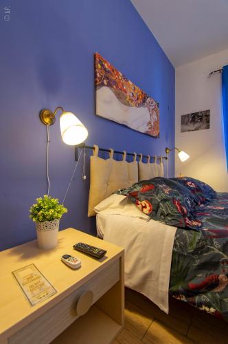 a bedroom with a bed and a table with a night stand at B & B San Cataldo in San Cataldo