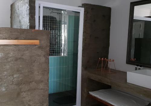 a bathroom with a shower and a sink at Emmaus Apartment in Bloemfontein