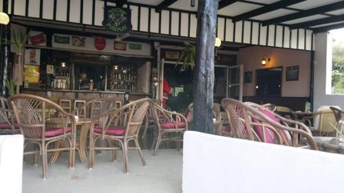 a group of chairs and tables in a restaurant at Hide Away Ipsos in Ýpsos