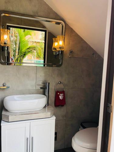 a bathroom with a sink and a mirror at Cieneguilla MolinoVerde in Cieneguilla