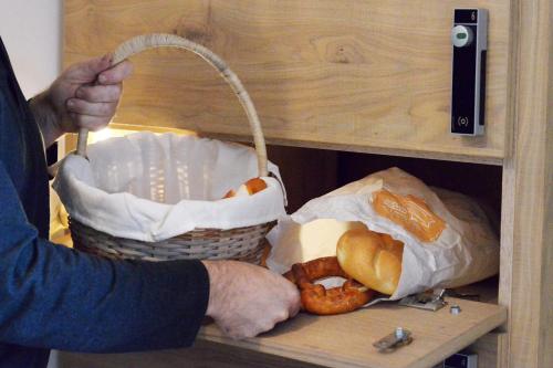 a person holding two baskets of food in a shelf at Birkenhof in Zell am Ziller