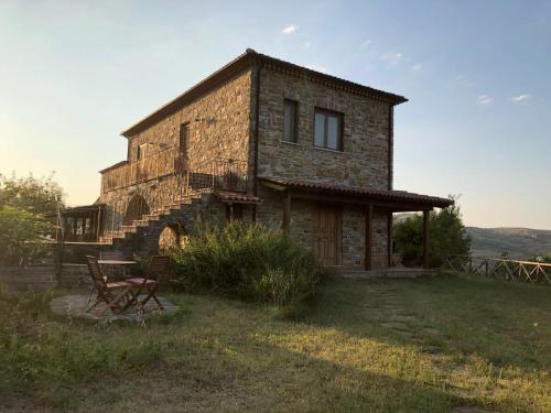 a stone house with a bench in front of it at Casa vacanze Il Mandorlo in Perdifumo